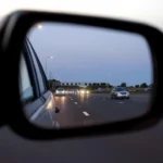 Clip-on rearview mirror monitor and replacement mirror monitor compared inside a car
