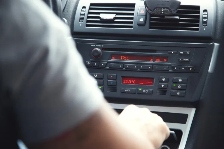 Car dashboard showing single DIN and double DIN radio fitment beside climate controls.