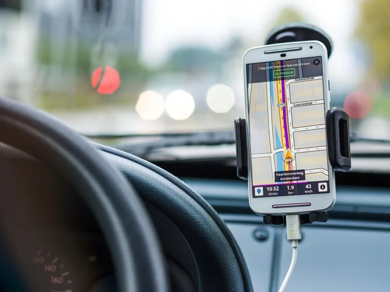 Driver in a car using wireless CarPlay on the dashboard during a morning commute