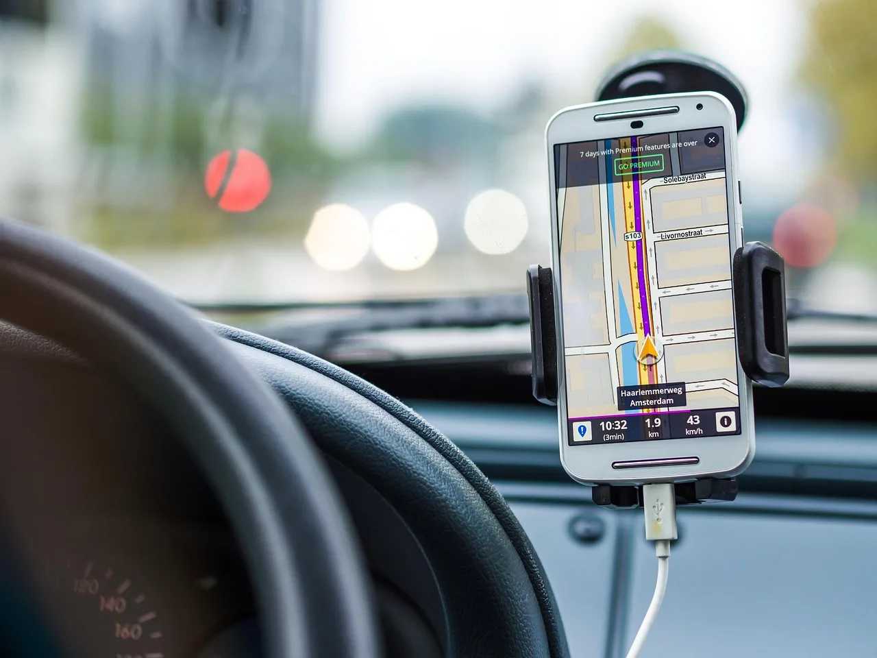Driver in a car using wireless CarPlay on the dashboard during a morning commute